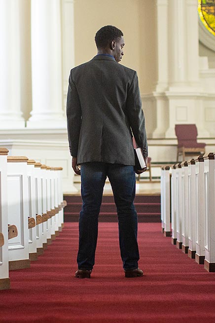 Chike Uzuegbunam standing in a church
