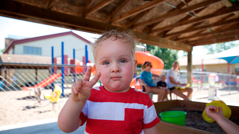 Trinity Lutheran boy holding up peace sign
