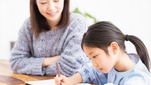 A mother and daughter study together.