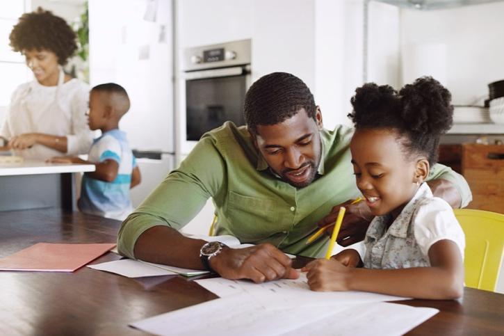 Father and Daughter Doing Homework Together